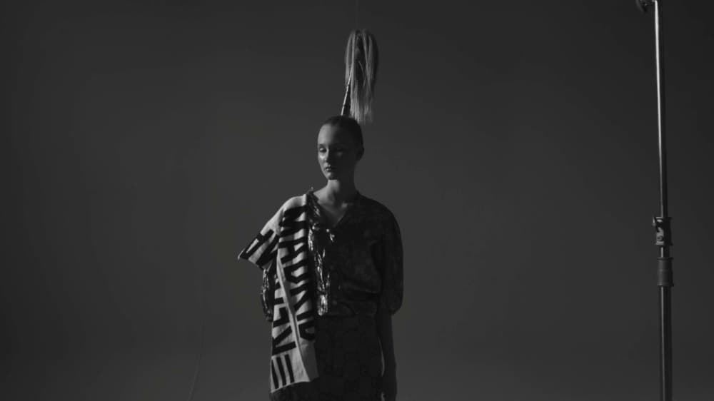 White Light model standing beside visible studio equipment