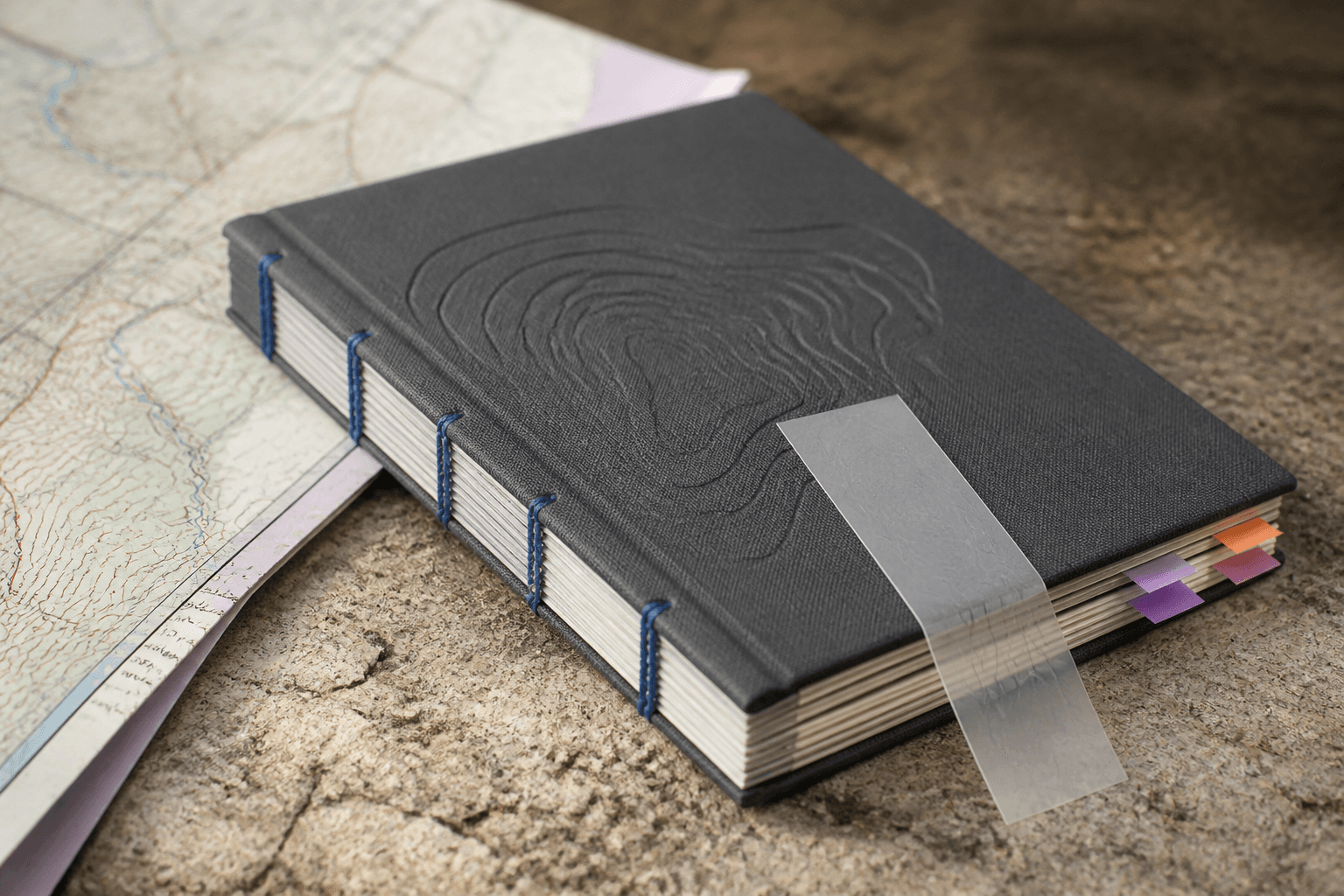 Clothbound field guide with exposed blue thread and index tabs